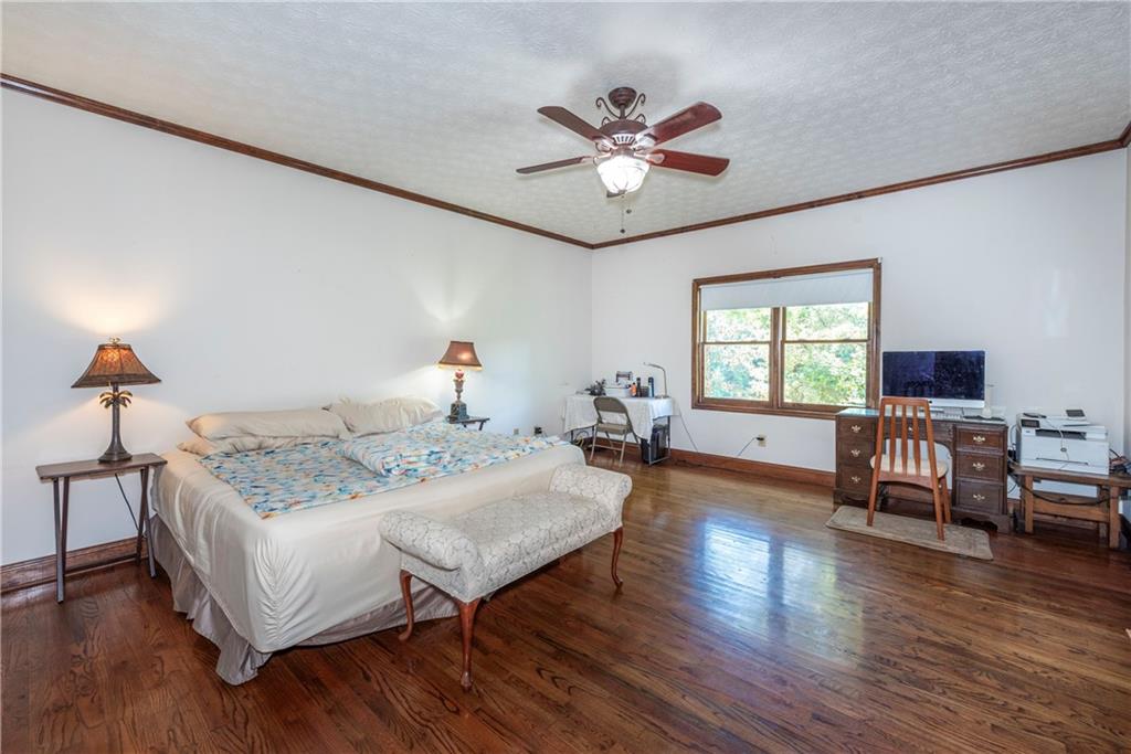 755 Harris Road Jasper, GA 30143 - Photo 31 of 54 a bedroom with a bed and a chandelier
