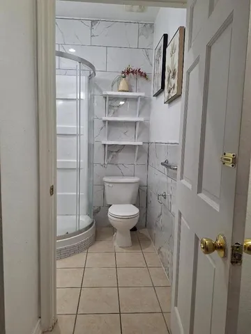 a bathroom with a toilet and a shower