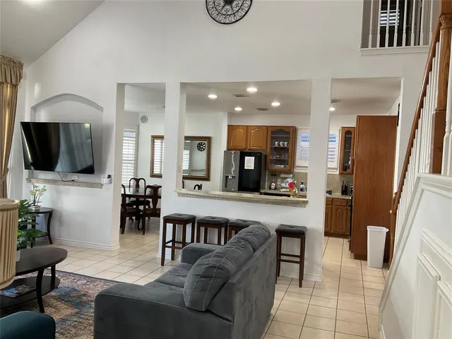 a kitchen with stainless steel appliances granite countertop a sink counter space cabinets and a large window