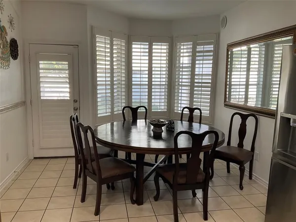 a view of a a dining room with furniture window and outside view