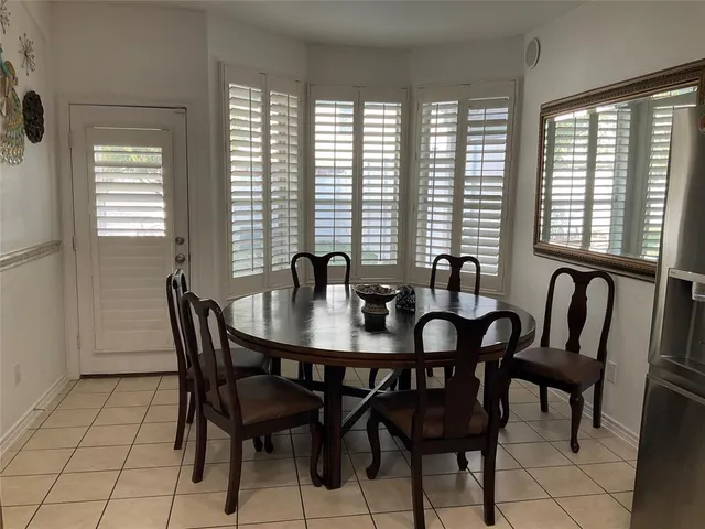 a view of a a dining room with furniture window and outside view