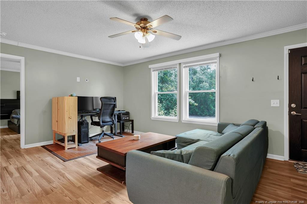 8155 Arabia Road Lumber Bridge, NC 28357 - Photo 6 of 30 a living room with furniture and a flat screen tv