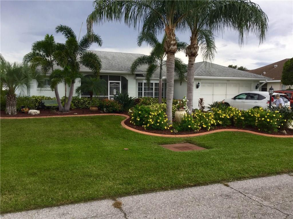 FANTASTIC STREET APPEAL, TROPICAL LANDSCAPE, PALM TREES, FLOWER BEDS OUTLINED WITH CONCRETE CURBING  IMPECCABLE LAWN