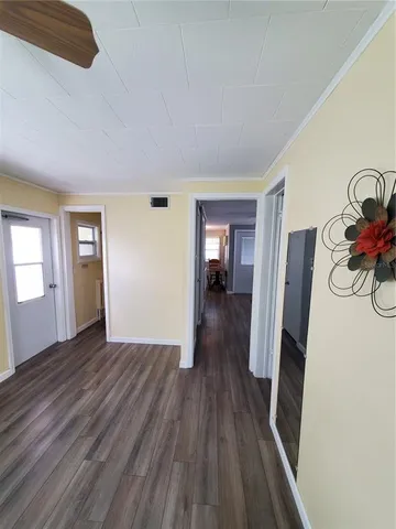 a room with water heater and wooden cabinets