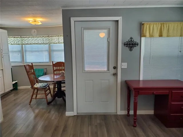a view of a workspace with furniture and wooden floor