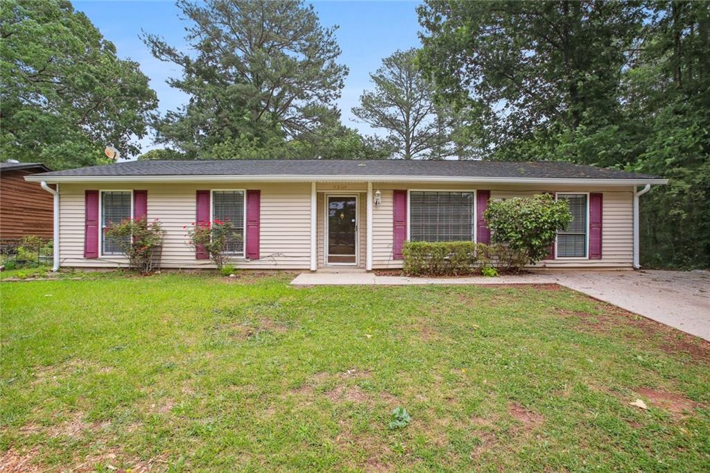 a front view of house with yard and outdoor seating