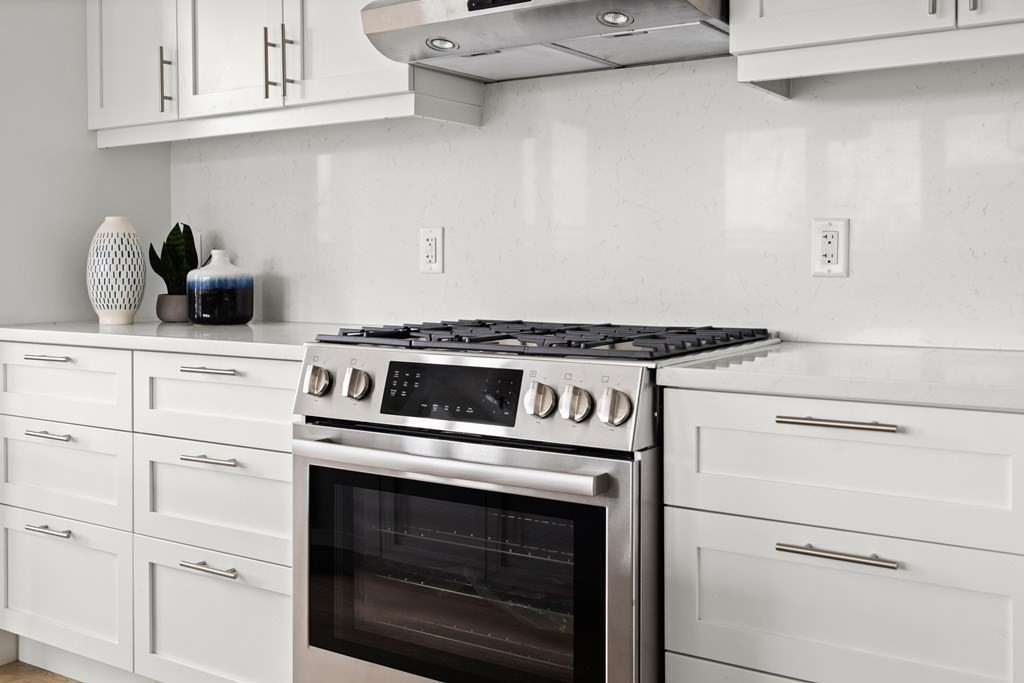 301 Border Street, Unit 406 Boston, MA 02128 - Photo 12 of 38 a stove top oven sitting inside of a kitchen