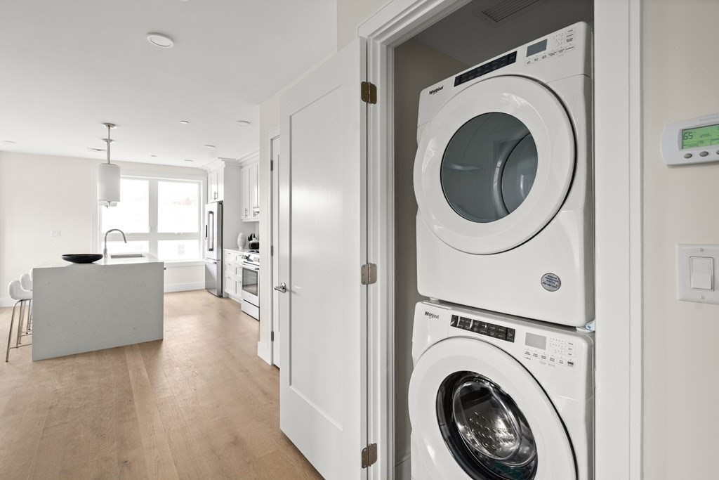 301 Border Street, Unit 406 Boston, MA 02128 - Photo 13 of 38 a view of a hallway with washer and dryer