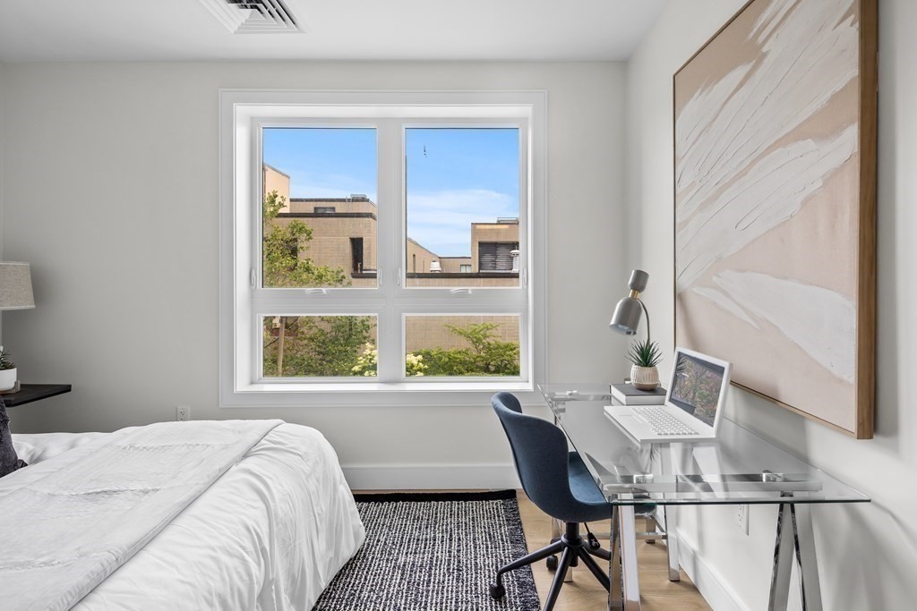 301 Border Street, Unit 406 Boston, MA 02128 - Photo 15 of 38 a bedroom with a bed and a window