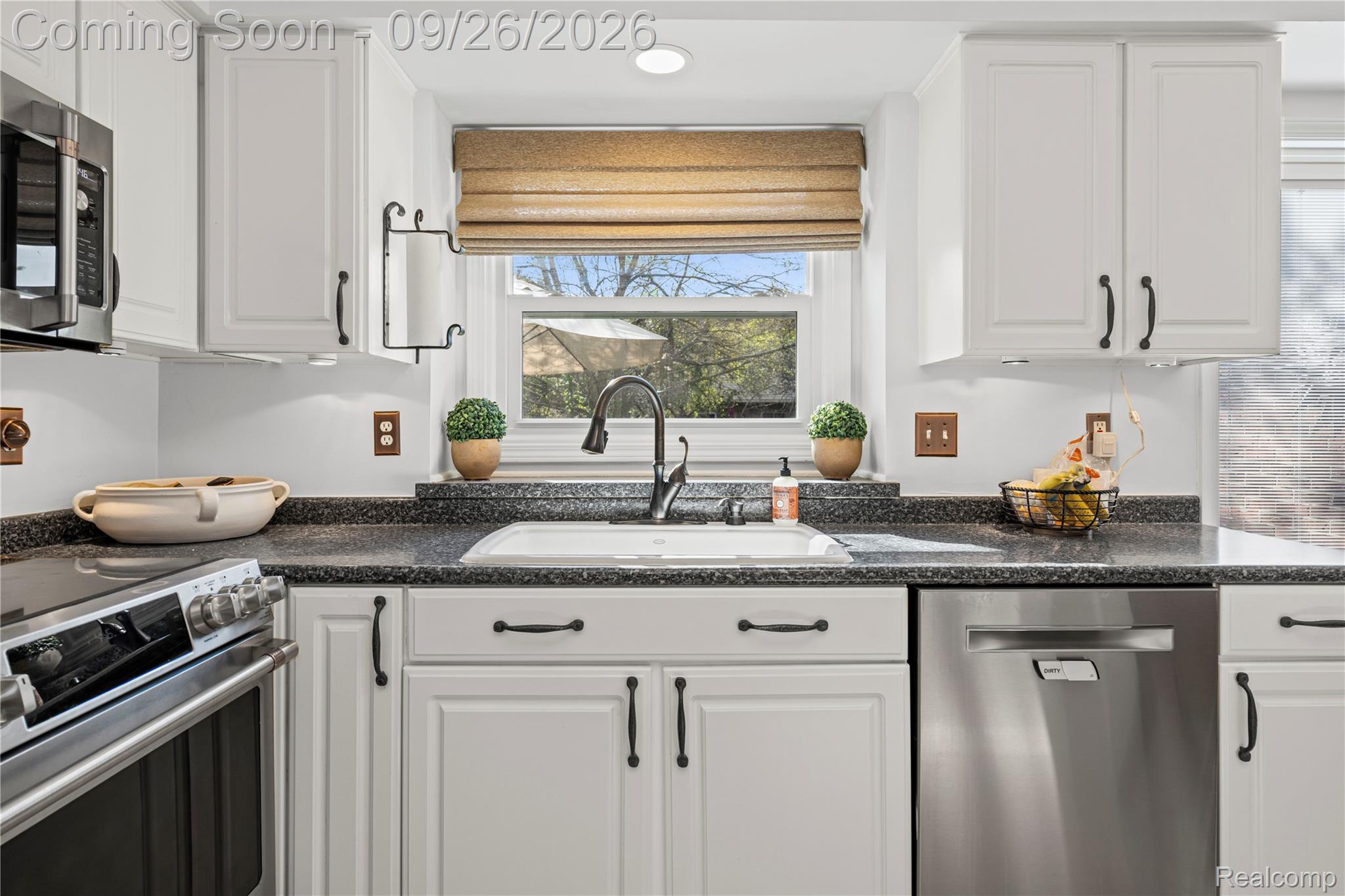 7021 Fox Path Canton, MI 48187 - Photo 19 of 59 White cabinetry with black hardware, dark speckled countertops, and a stainless steel appliance suite