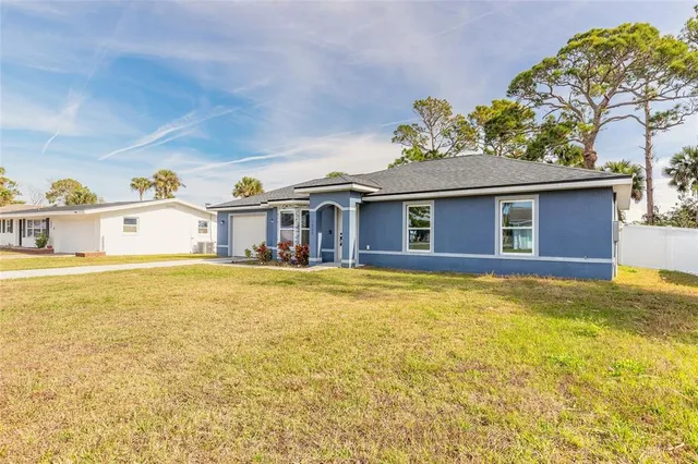 a front view of house with yard and outdoor seating
