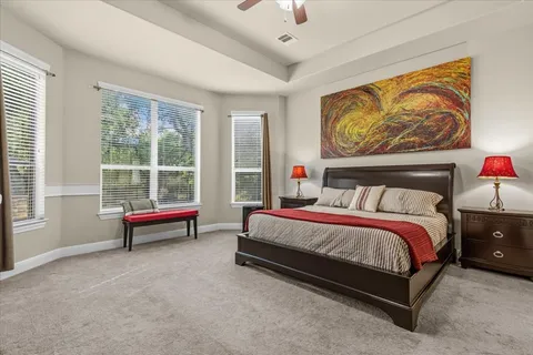 a spacious bedroom with a bed and a window