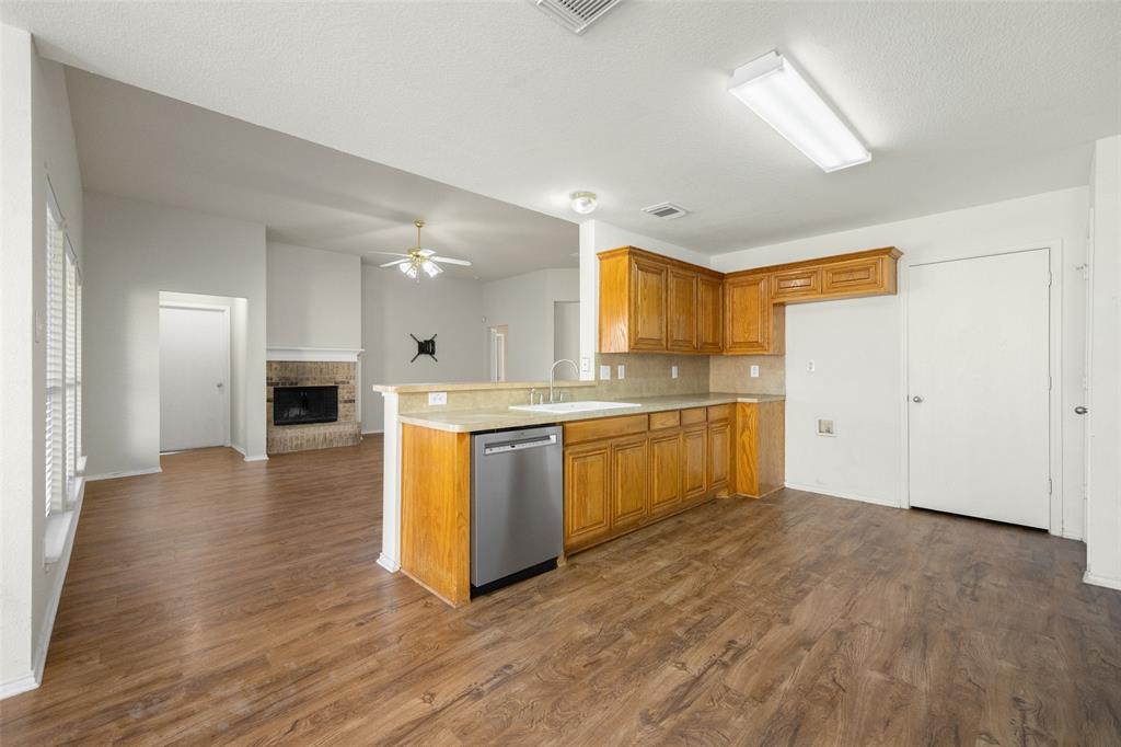 324 Meadow Ridge Drive Anna, TX 75409 - Photo 10 of 32 Kitchen overlooks the living, check out that new stainless dishwasher