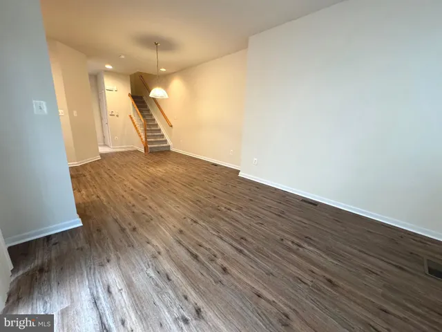 a view of a room with wooden floor