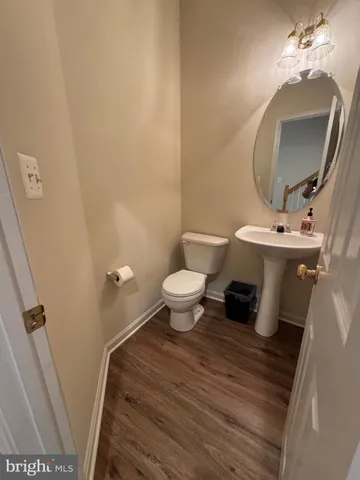 a bathroom with a sink toilet and a mirror