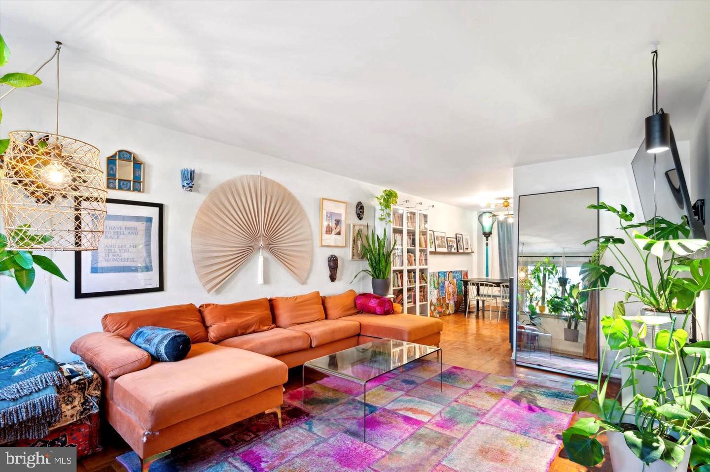 4572 Manayunk Avenue Philadelphia, PA 19128 - Photo 1 of 22 a living room with furniture a rug and flowers