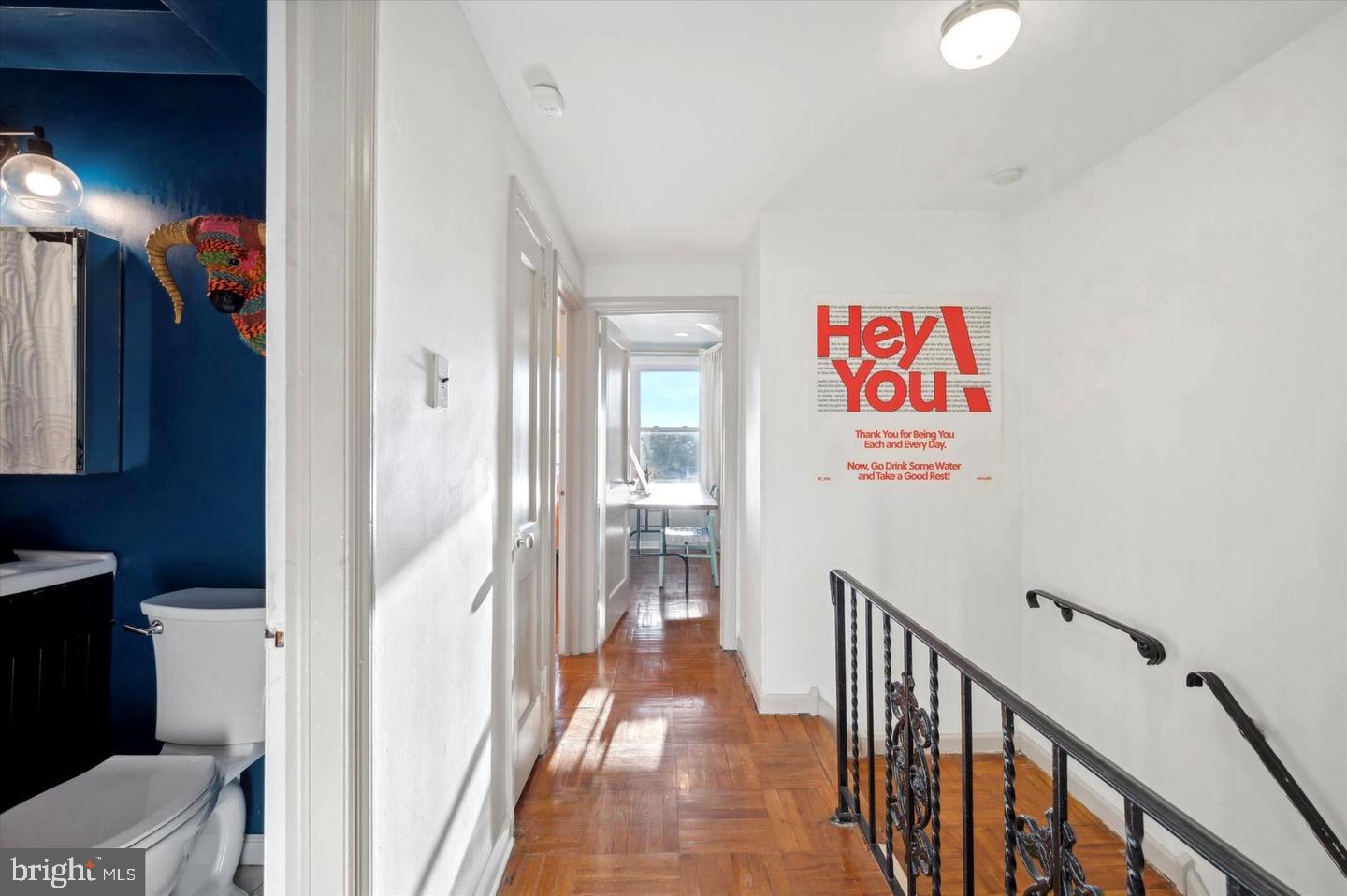 4572 Manayunk Avenue Philadelphia, PA 19128 - Photo 12 of 22 a view of a hallway to a livingroom with wooden floor and furniture
