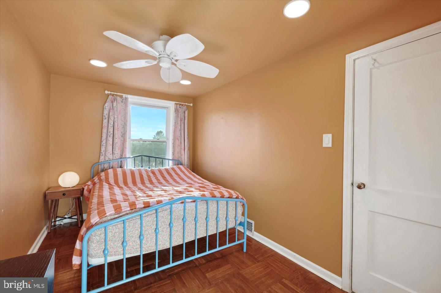 4572 Manayunk Avenue Philadelphia, PA 19128 - Photo 14 of 22 a bedroom with a bed and a chandelier