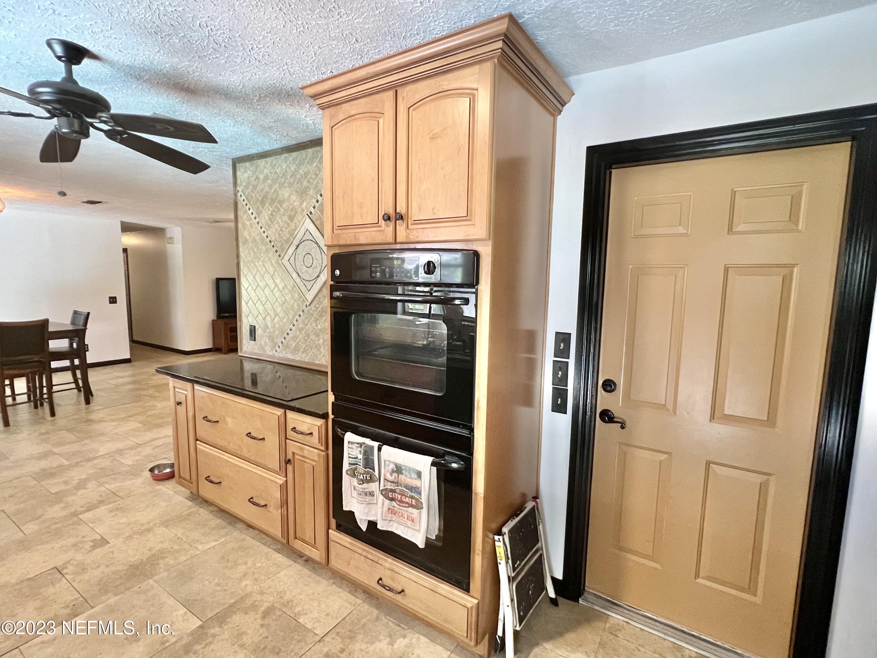 210 Prince Road St. Augustine, FL 32086 - Photo 11 of 43 a kitchen with stainless steel appliances granite countertop a refrigerator and a stove