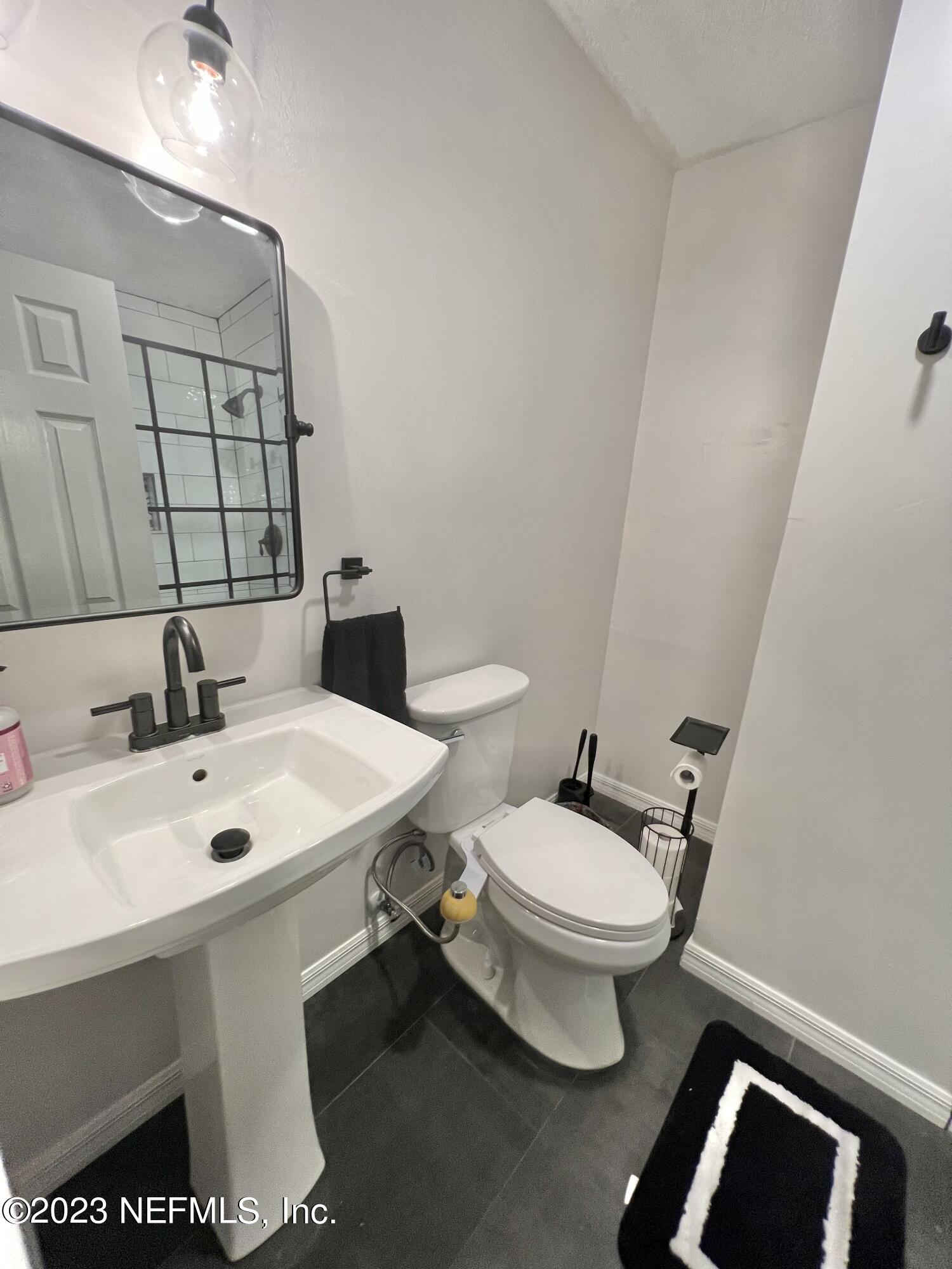 210 Prince Road St. Augustine, FL 32086 - Photo 15 of 43 a white toilet sitting next to a bathroom sink