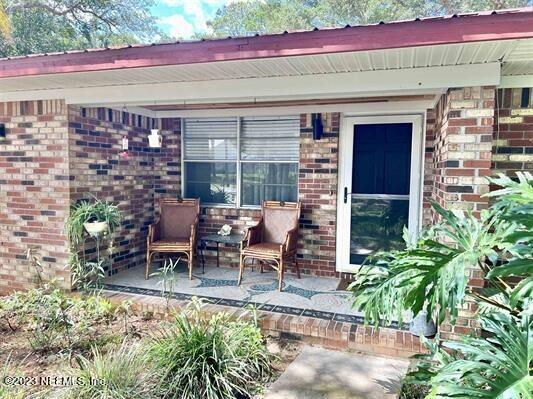 210 Prince Road St. Augustine, FL 32086 - Photo 2 of 43 a view of a patio with table and chairs potted plants and a bench