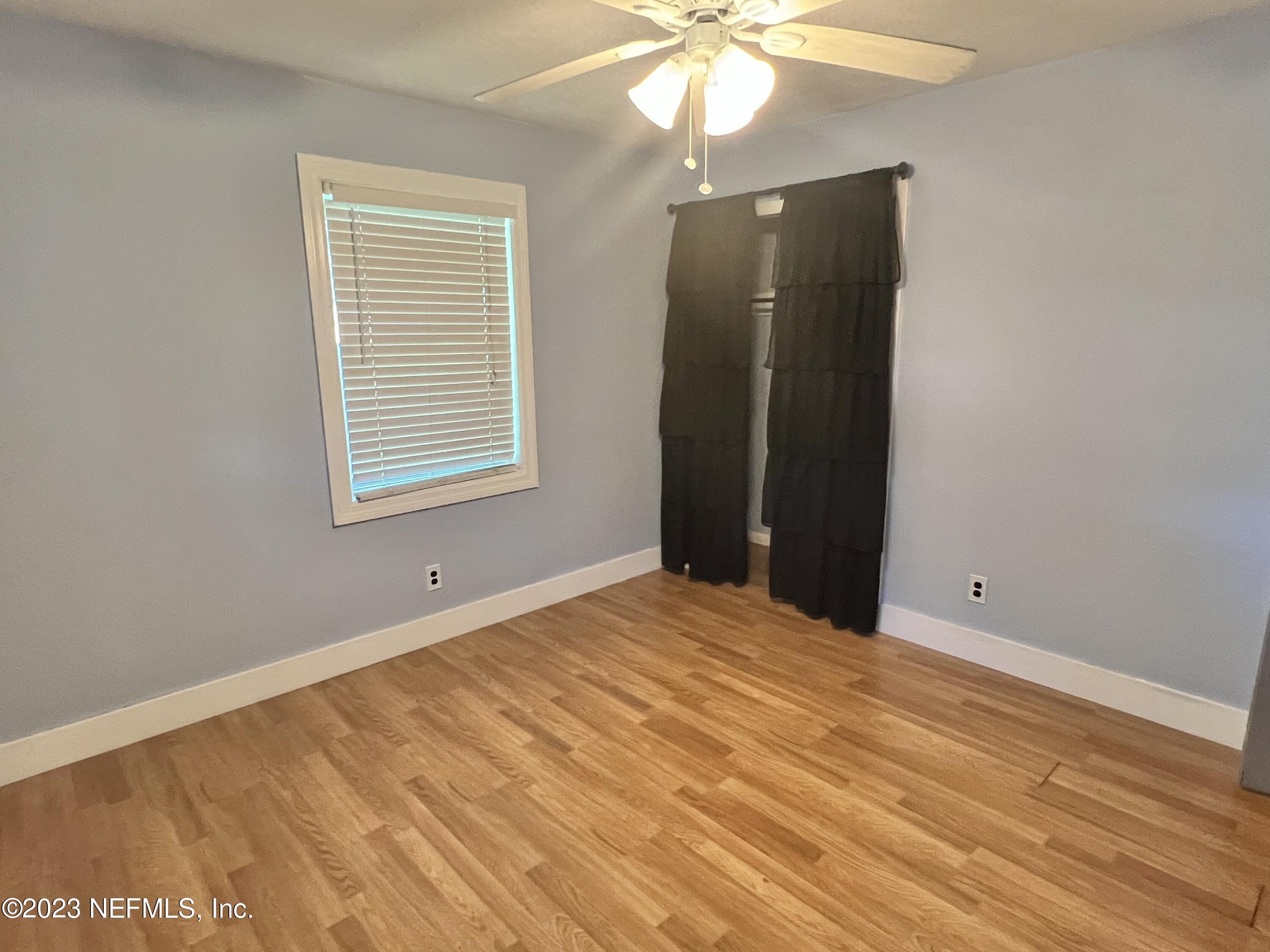 210 Prince Road St. Augustine, FL 32086 - Photo 25 of 43 an empty room with wooden floor and windows