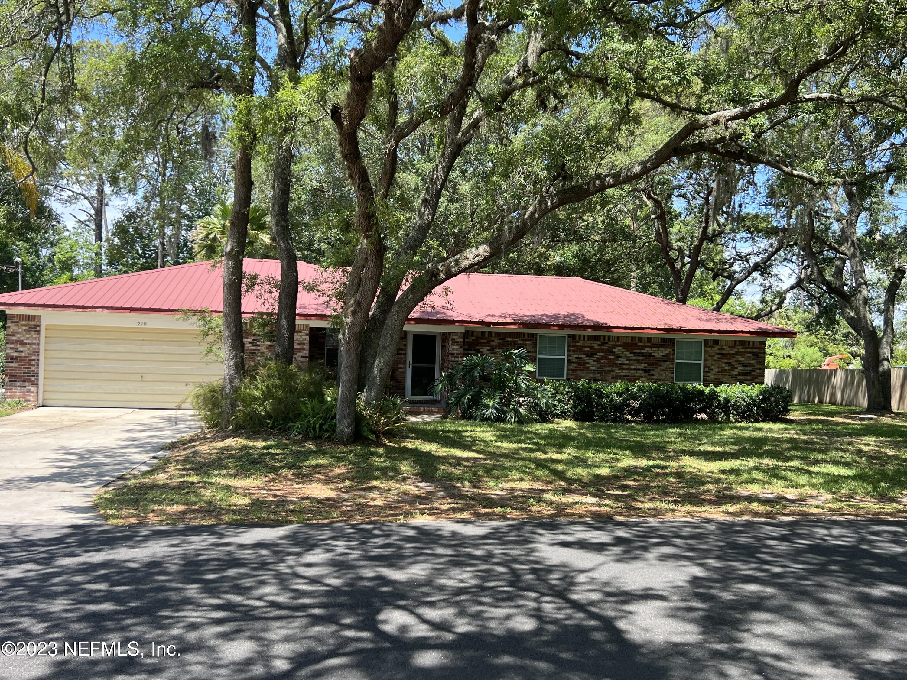 210 Prince Road St. Augustine, FL 32086 - Photo 4 of 43 a backyard of a house with yard and outdoor seating