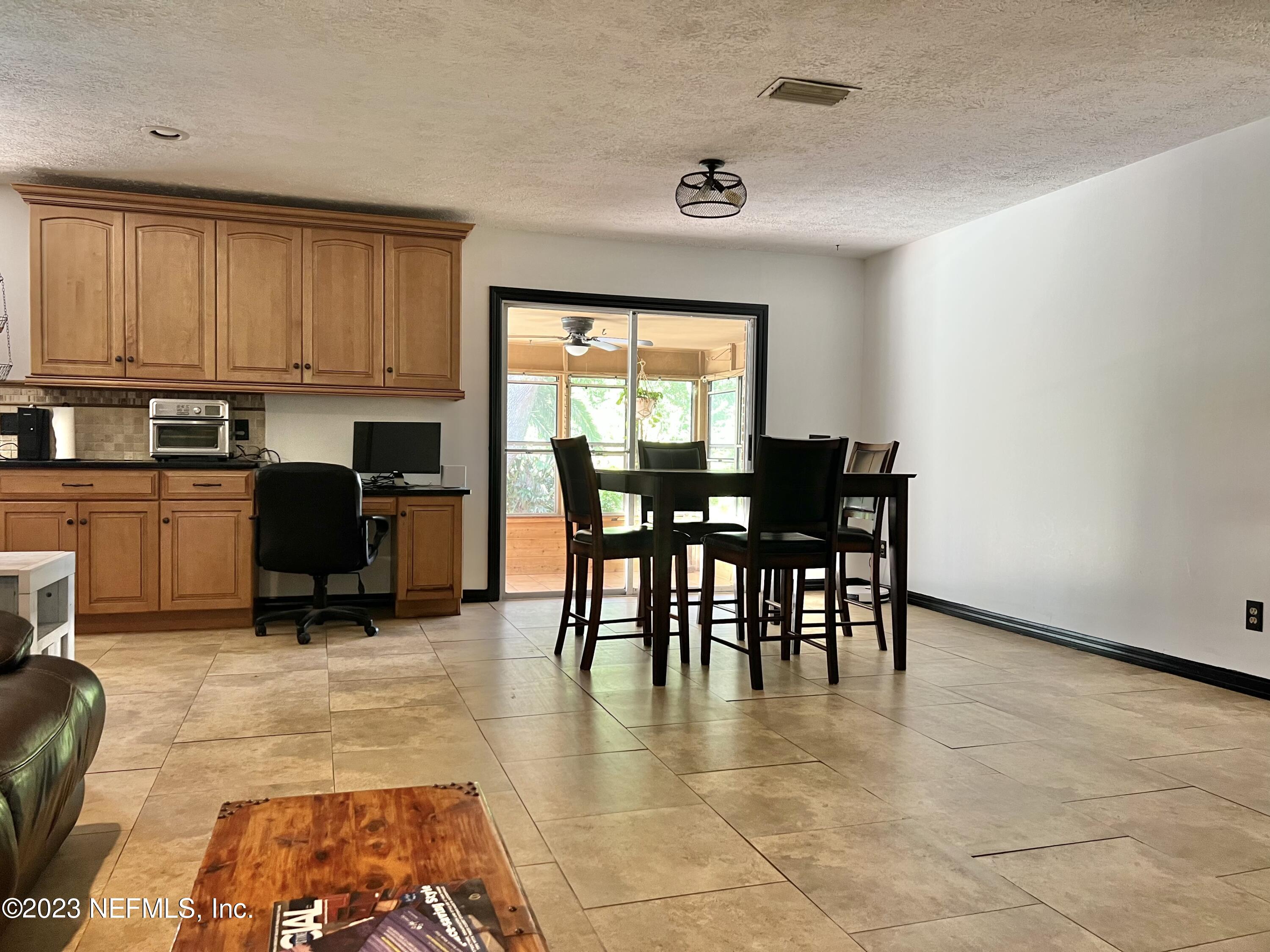 210 Prince Road St. Augustine, FL 32086 - Photo 6 of 43 a dining room with furniture and a floor to ceiling window