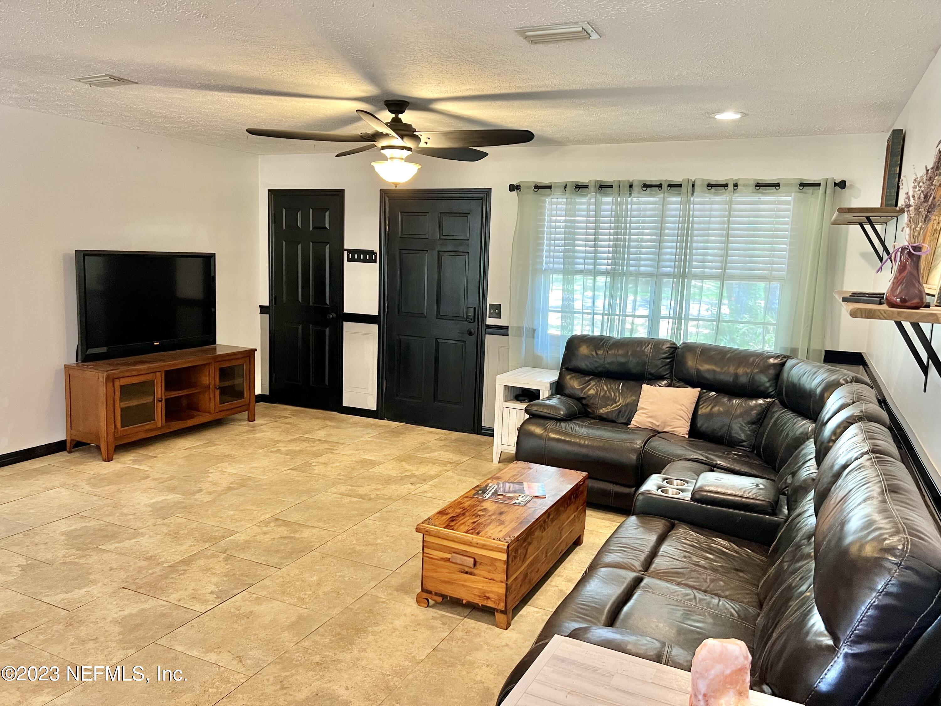 210 Prince Road St. Augustine, FL 32086 - Photo 7 of 43 a living room with furniture and a flat screen tv