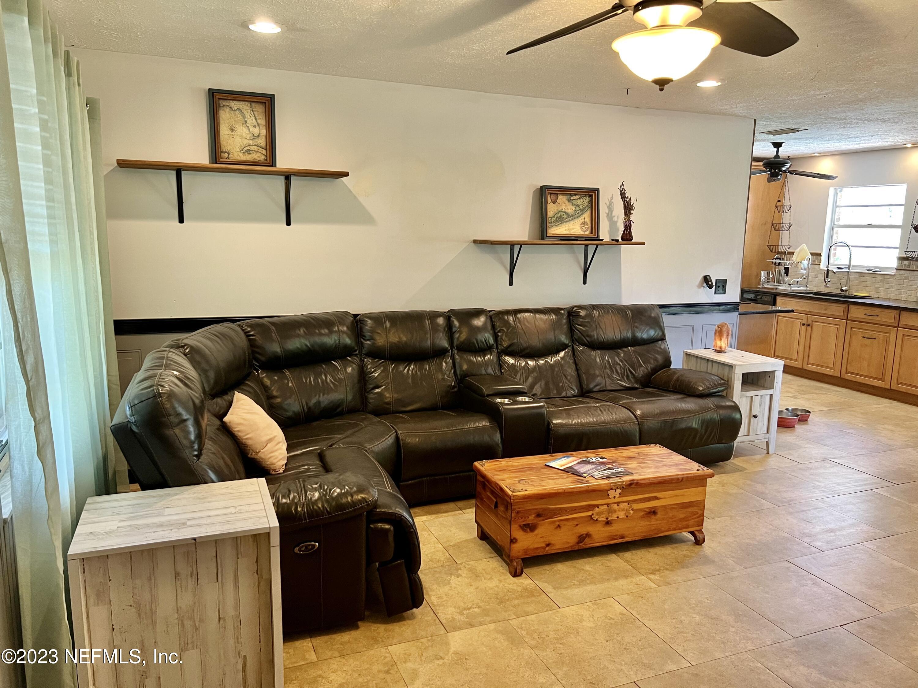 210 Prince Road St. Augustine, FL 32086 - Photo 9 of 43 a living room with furniture and a flat screen tv