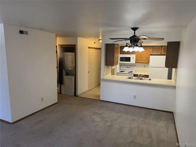 a view of kitchen with stainless steel appliances wooden floor