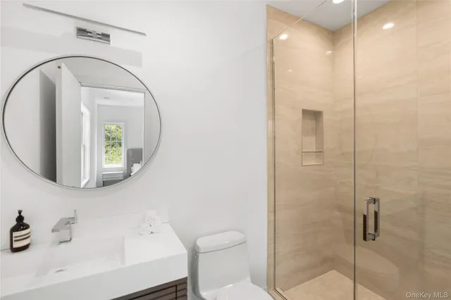 a bathroom with a toilet sink and shower