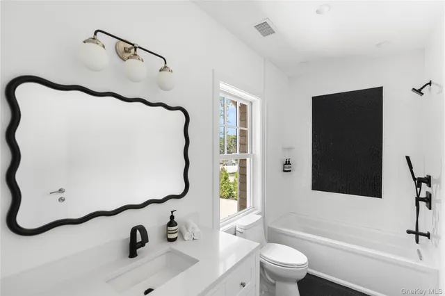 a bathroom with a sink and mirror