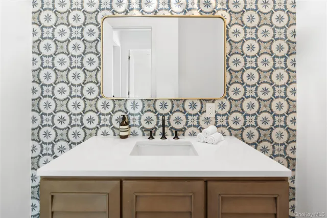 a bathroom with a sink and a mirror