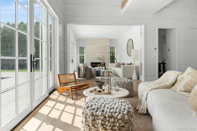 a living room with furniture fireplace and a large window
