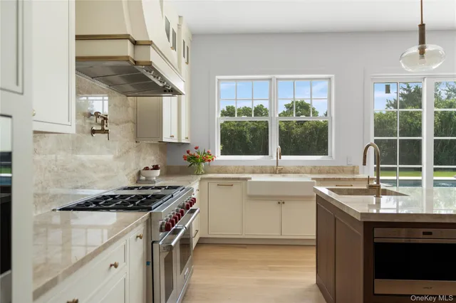 a kitchen with a sink stove top oven and cabinets