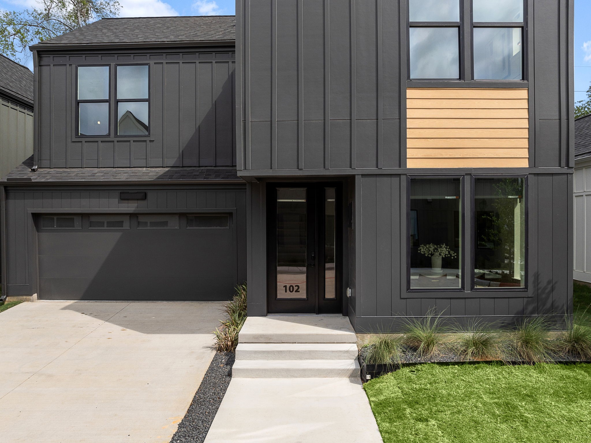 1941 Sawdust Road, Unit 154 The Woodlands, TX 77380 - Photo 2 of 38 a front view of a house with a yard