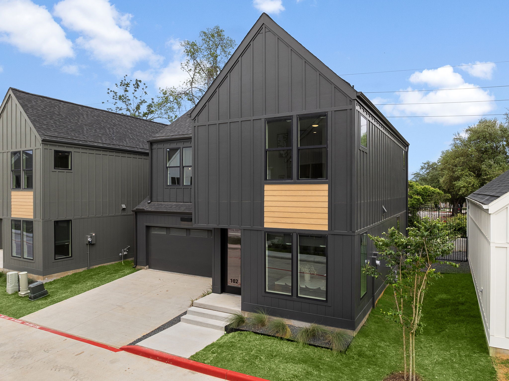 1941 Sawdust Road, Unit 154 The Woodlands, TX 77380 - Photo 4 of 38 a front view of a house with a garden and yard