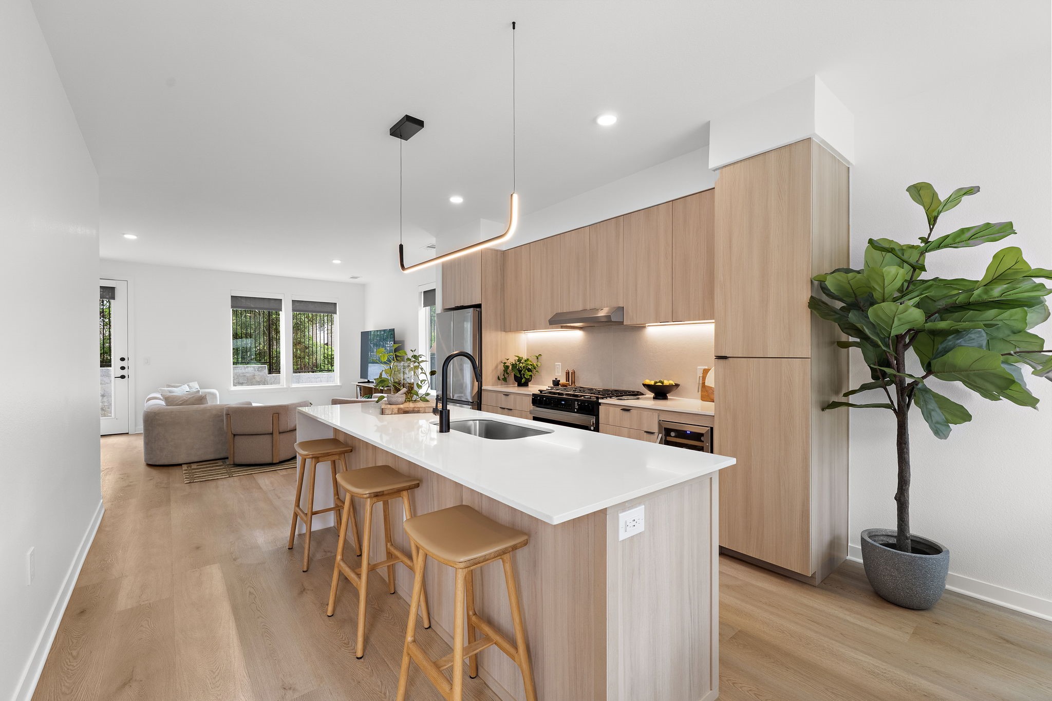 1941 Sawdust Road, Unit 154 The Woodlands, TX 77380 - Photo 9 of 38 a kitchen with a sink a counter and chairs