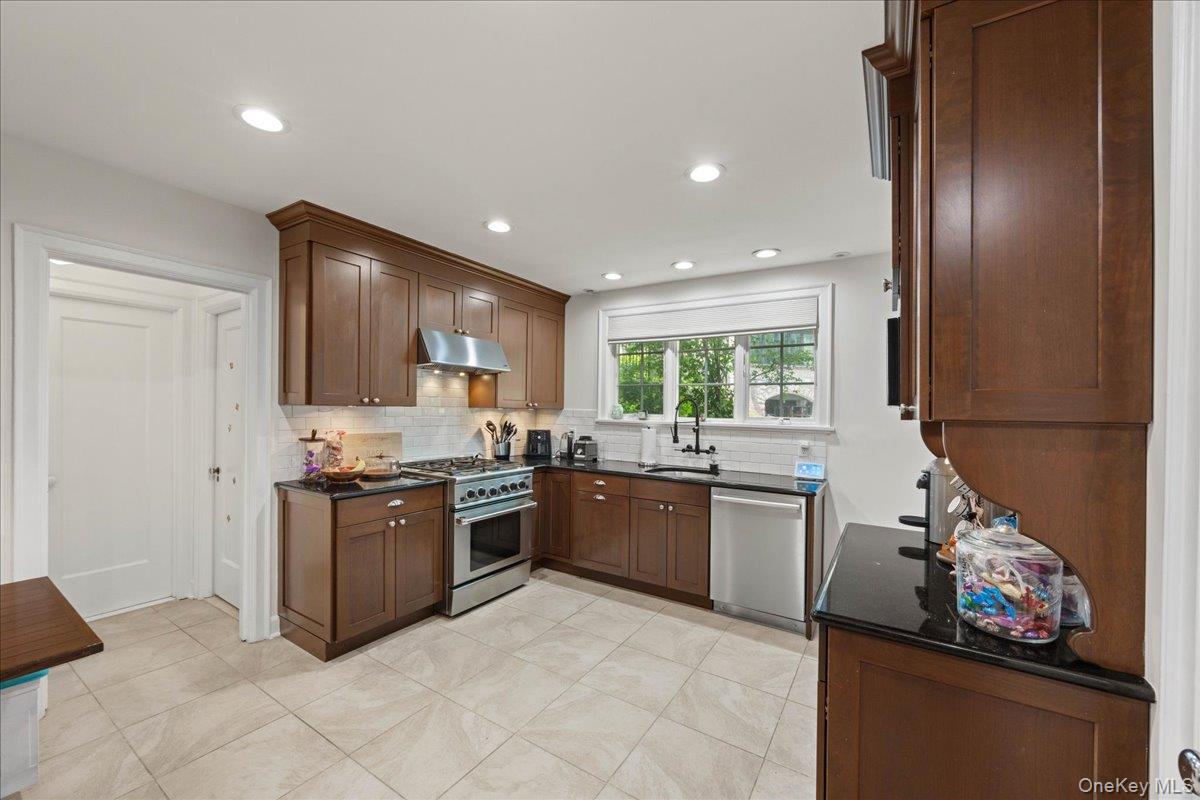 311 Lyncroft Road New Rochelle, NY 10804 - Photo 11 of 39 a large kitchen with stainless steel appliances granite countertop a stove sink and refrigerator
