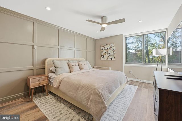 a bedroom with a bed and a mirror