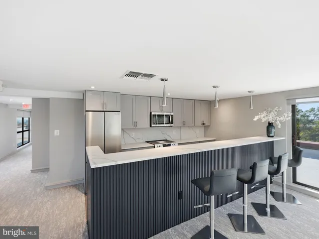 a living room with furniture and large windows