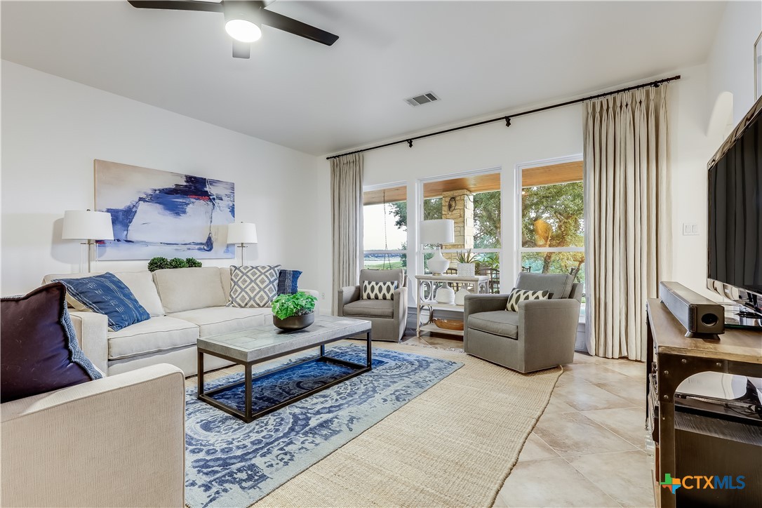 1307 Osprey Ridge Loop Lago Vista, TX 78645 - Photo 18 of 40 a living room with furniture and a flat screen tv