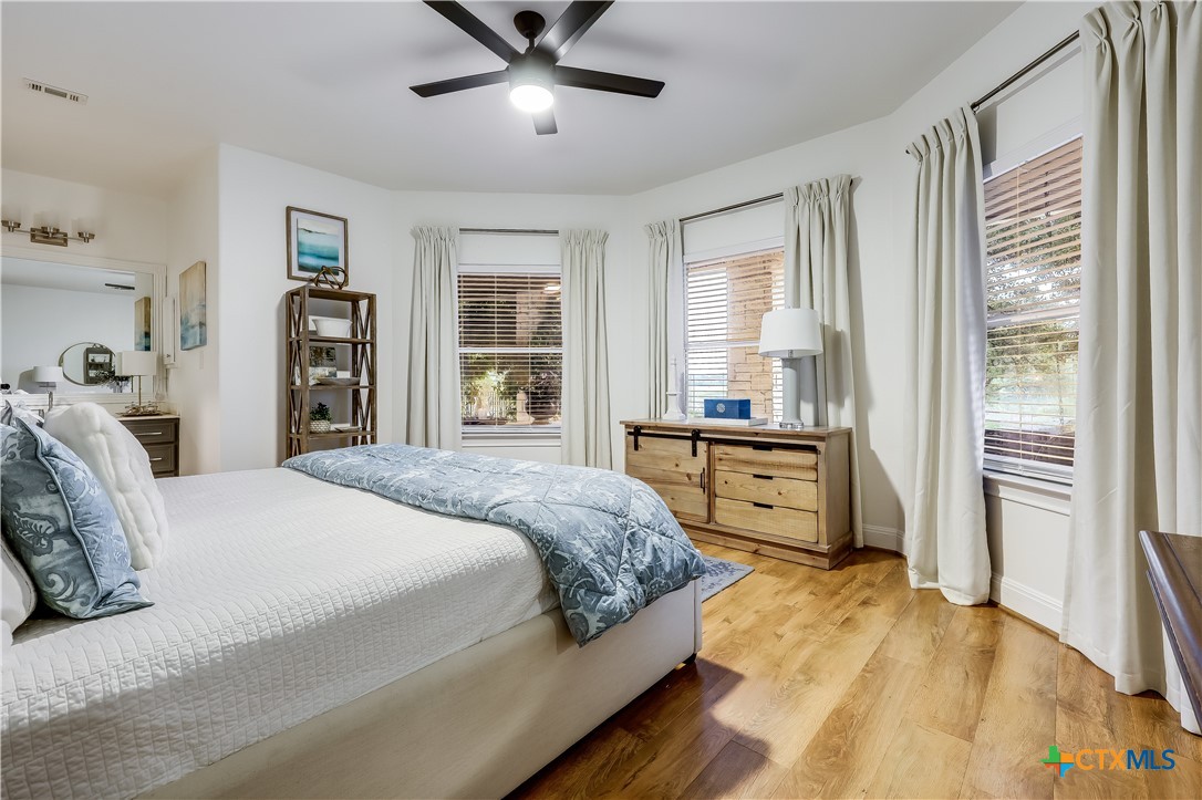 1307 Osprey Ridge Loop Lago Vista, TX 78645 - Photo 20 of 40 a bedroom with a large bed and a window