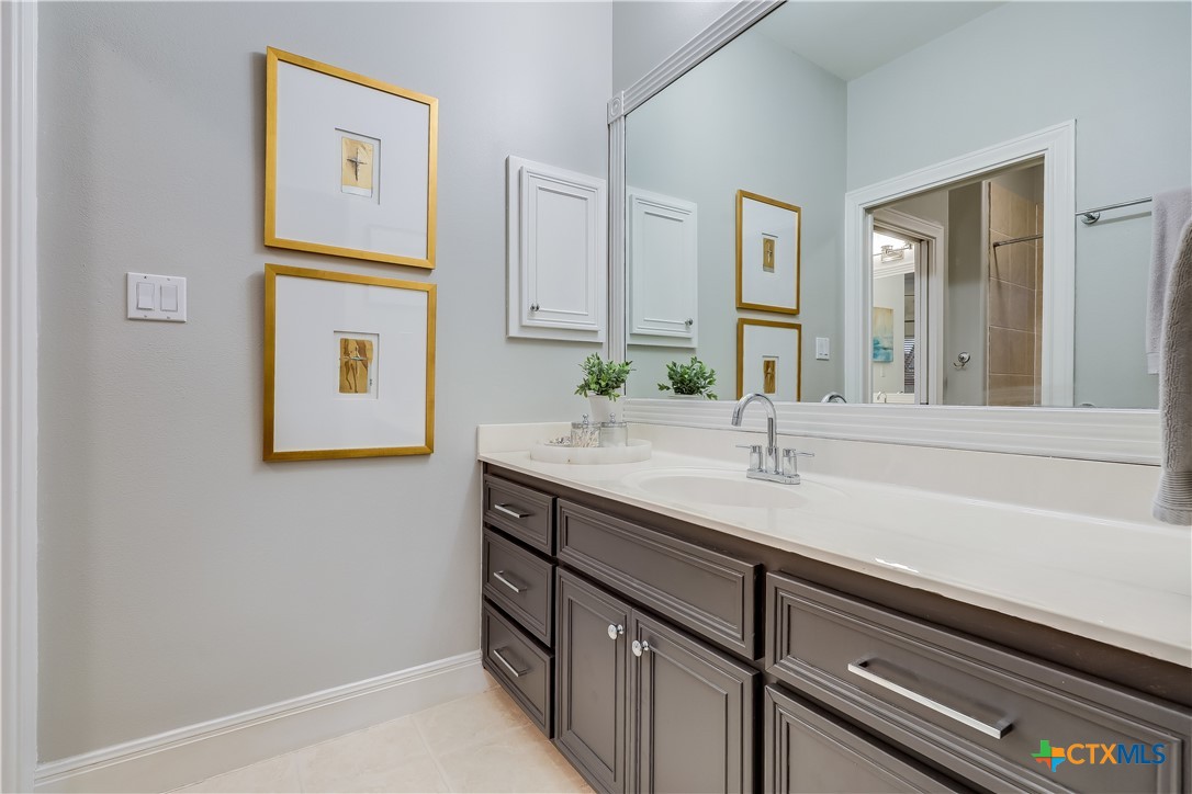 1307 Osprey Ridge Loop Lago Vista, TX 78645 - Photo 22 of 40 a bathroom with a sink and a mirror