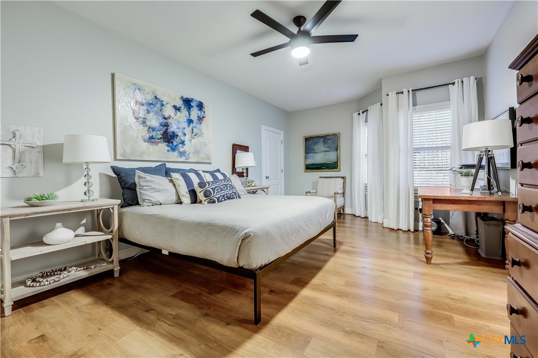 1307 Osprey Ridge Loop Lago Vista, TX 78645 - Photo 25 of 40 a spacious bedroom with a bed and a table in it