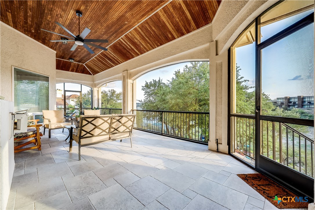 1307 Osprey Ridge Loop Lago Vista, TX 78645 - Photo 32 of 40 a view of a porch with furniture and floor to ceiling window