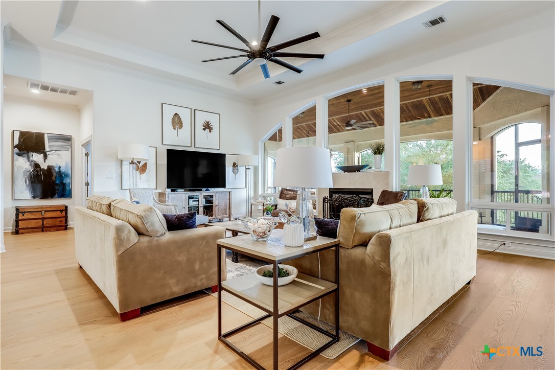 1307 Osprey Ridge Loop Lago Vista, TX 78645 - Photo 5 of 40 a living room with furniture a flat screen tv and a large window
