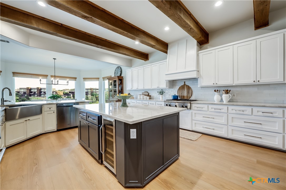 1307 Osprey Ridge Loop Lago Vista, TX 78645 - Photo 7 of 40 a kitchen with stainless steel appliances granite countertop a sink and cabinets