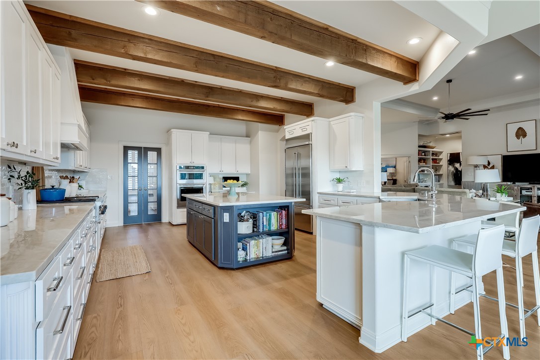 1307 Osprey Ridge Loop Lago Vista, TX 78645 - Photo 8 of 40 a kitchen with stainless steel appliances granite countertop a sink and cabinets